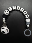 Personalisierte Fußball Schnullerkette mit dem Namen Kilian in Schwarz, Weiß und Grau
